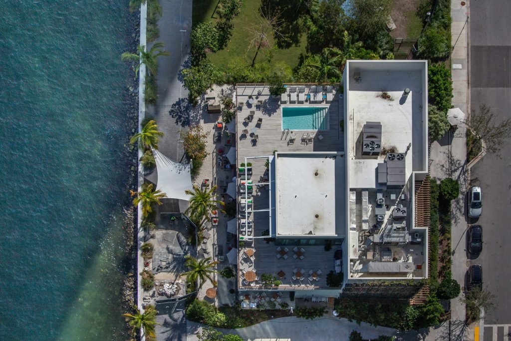 A waterfront property with pool decks and terraces, straight down
