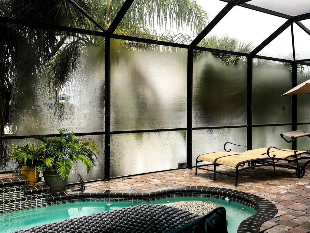 A screened lanai and pool — the second outdoor room these houses have