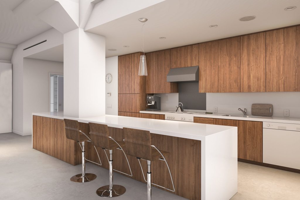 A white island with barstools in front of a full wall of walnut cabinetry