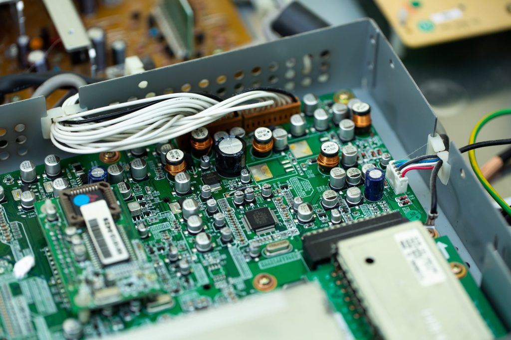 A control board in its metal chassis with the loom folded back